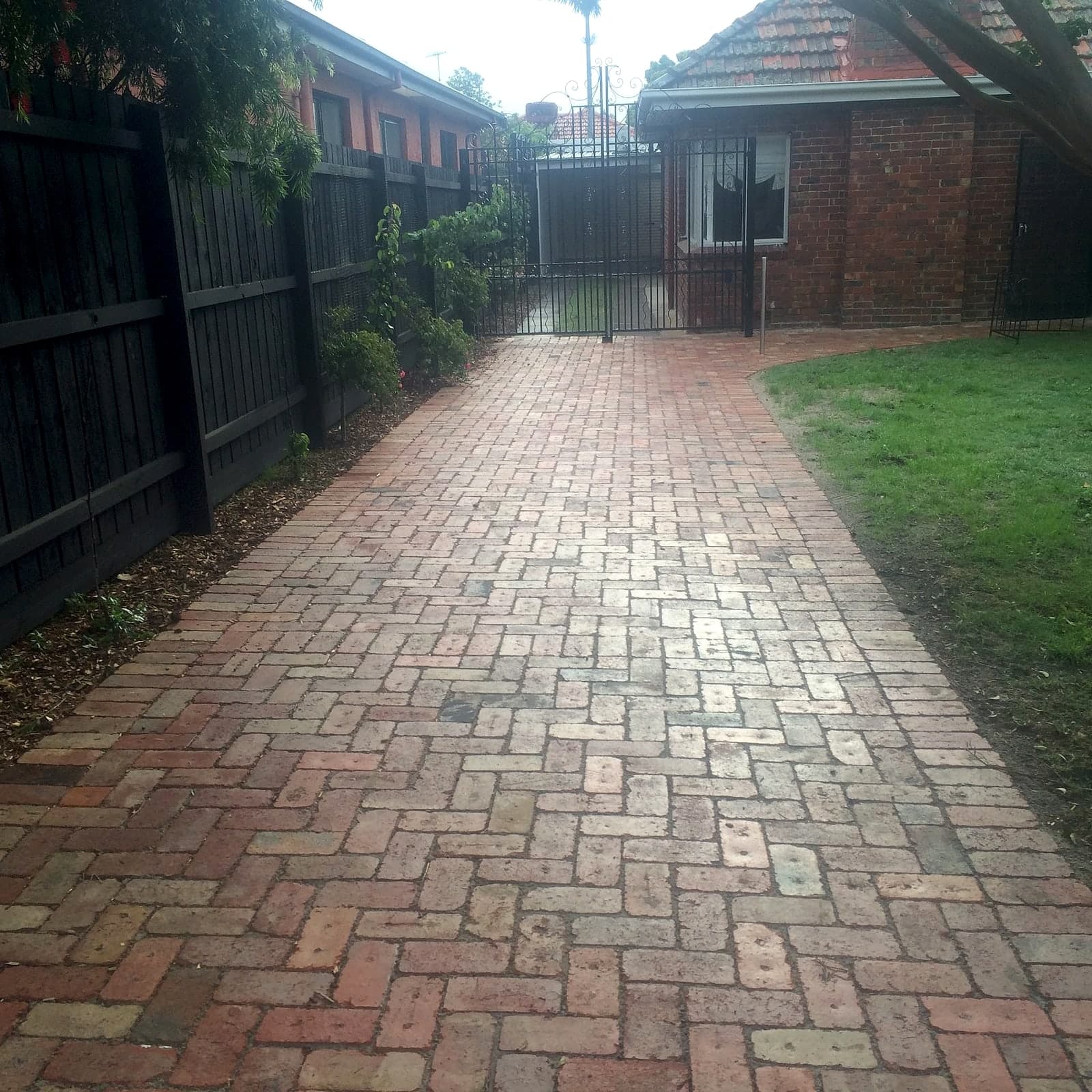 Brick driveway to rear garage by Cam Wells Paving