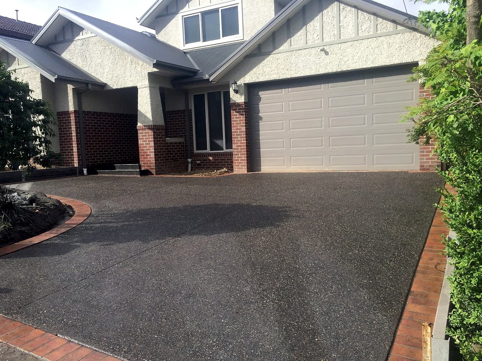 Aggregate with curved brick edging by Cam Wells Paving