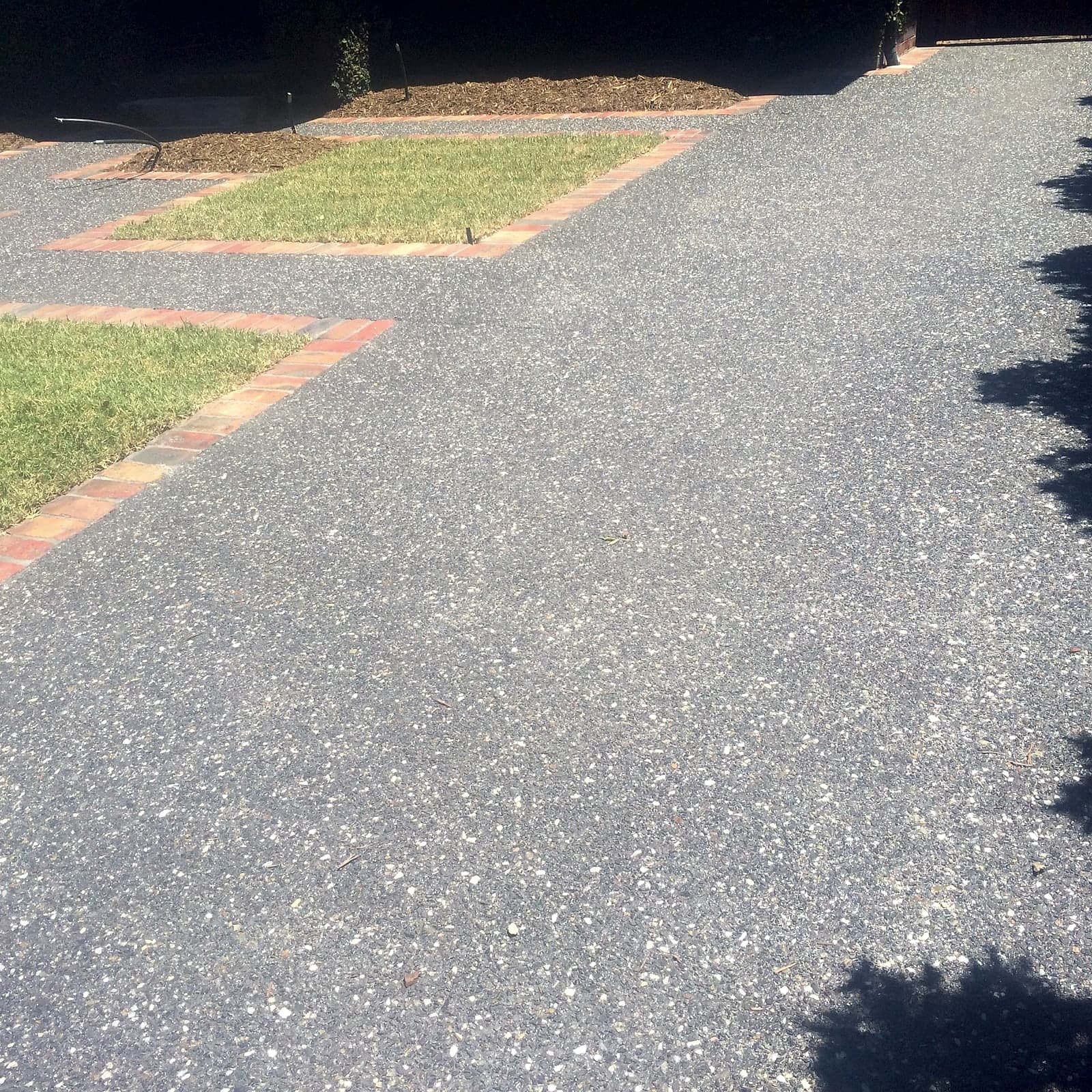 Grey aggregate with lawn panels by Cam Wells Paving
