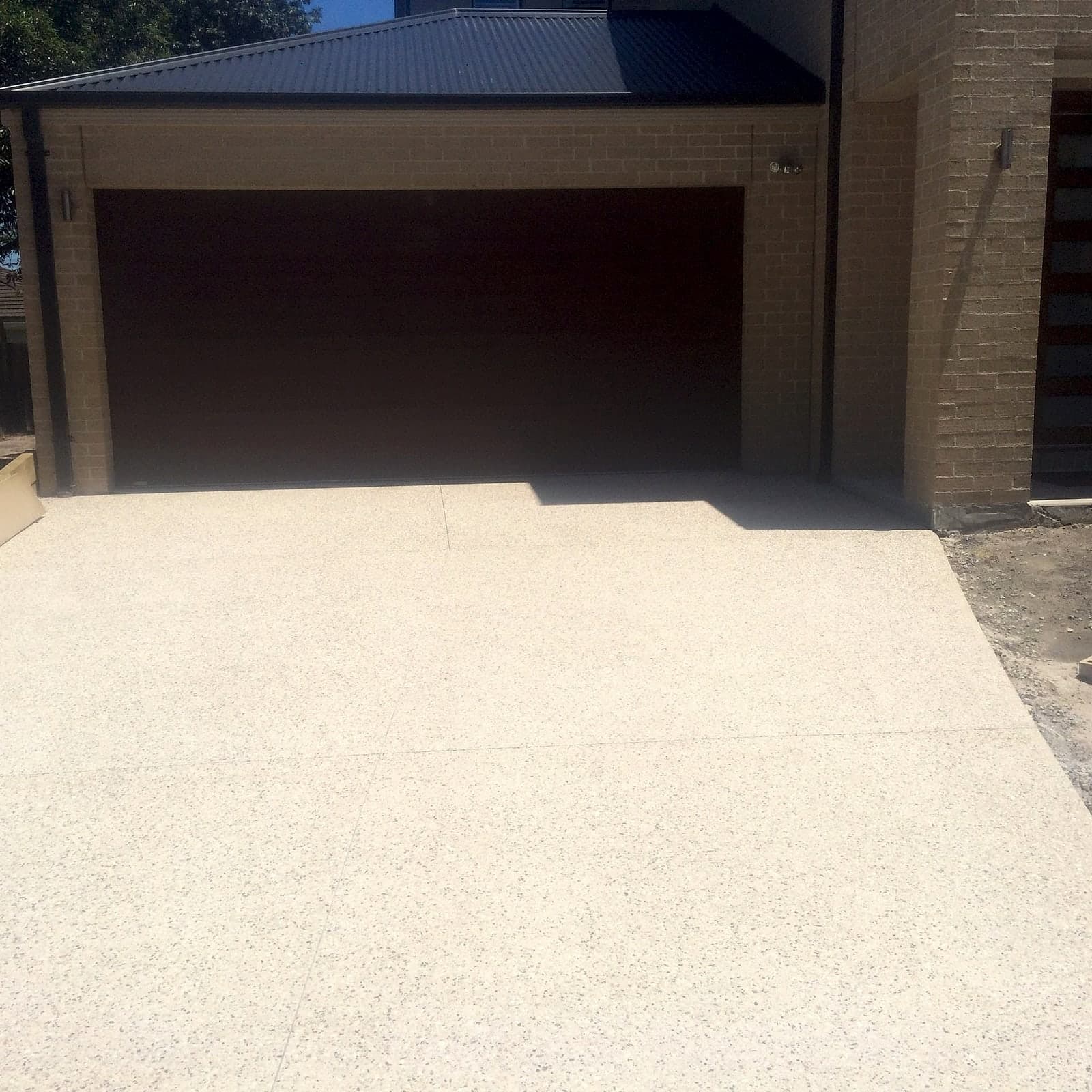 Light exposed aggregate driveway by Cam Wells Paving